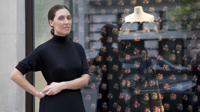 Fashion designer Emilia Wickstead standing besides a dress form.