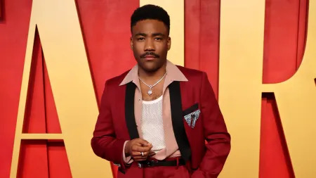 Donald Glover being well-dressed at a fashion event.